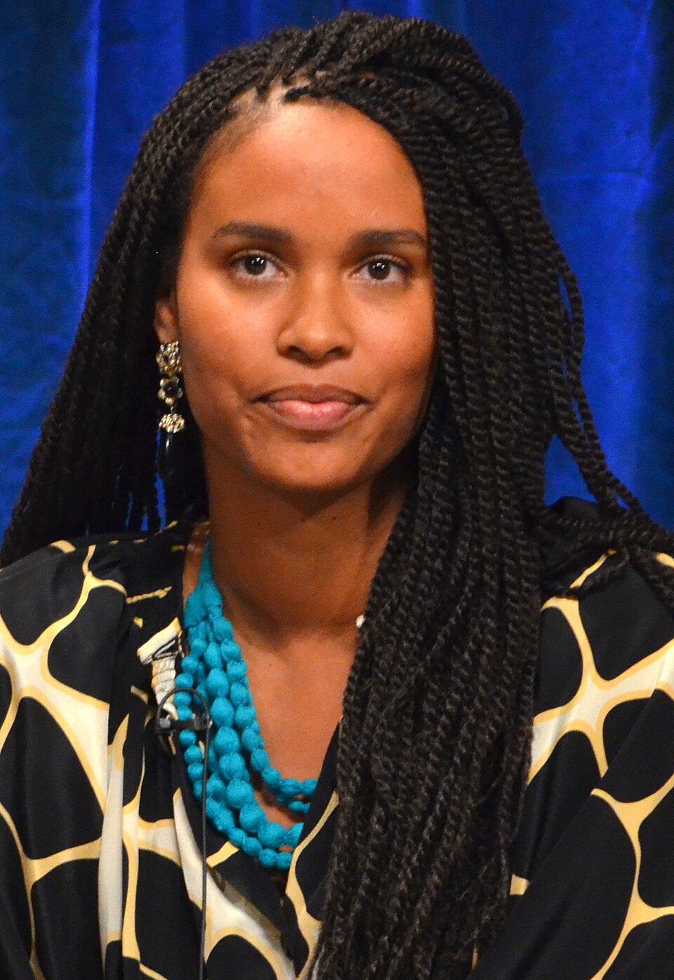 Woman with long styled braids — portrait